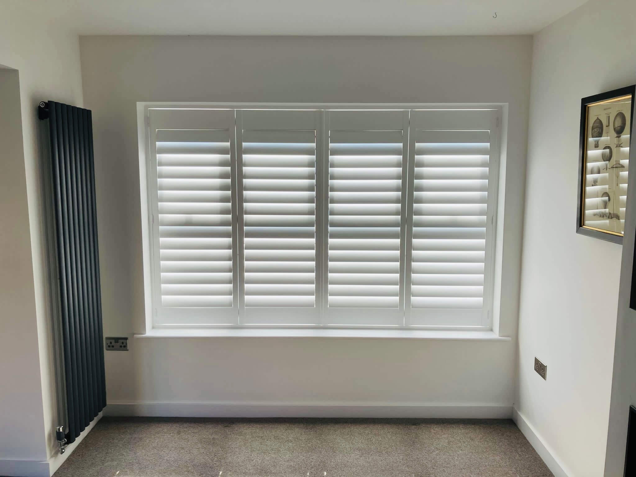 Full height plantation shutters in a bright living room