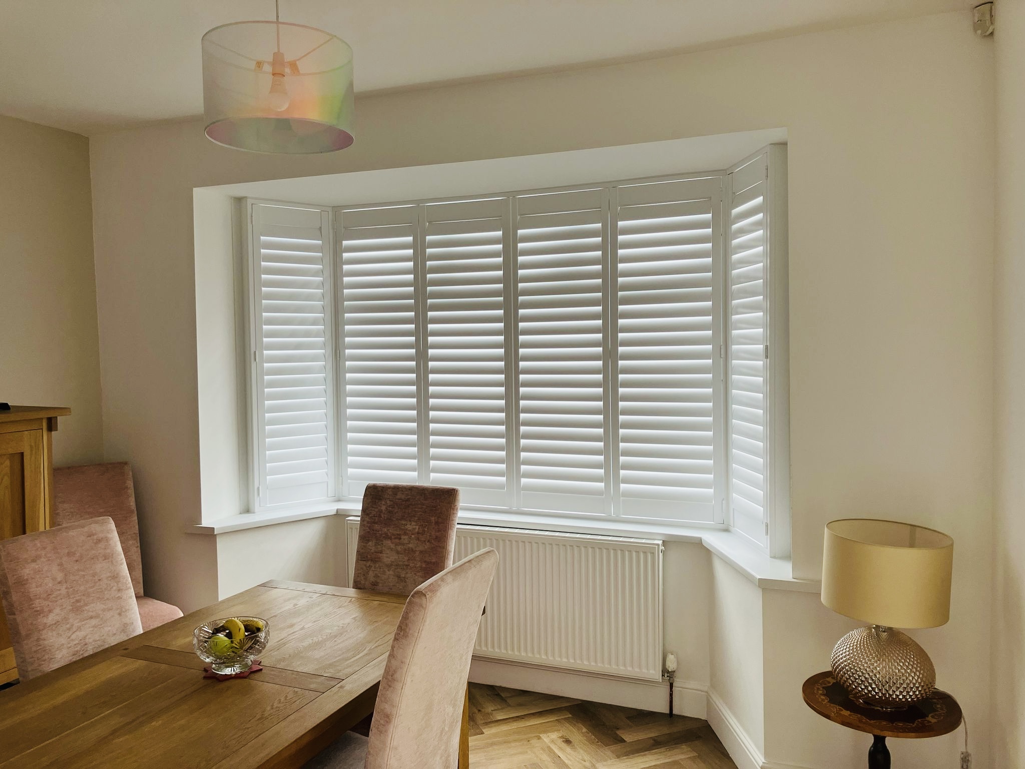Bay window plantation shutters fitted in a Norfolk home